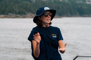 Gatherall's tour guide speaking on the boat for puffin and whale watching cruise in Newfoundland, showcasing marine wildlife adventure.